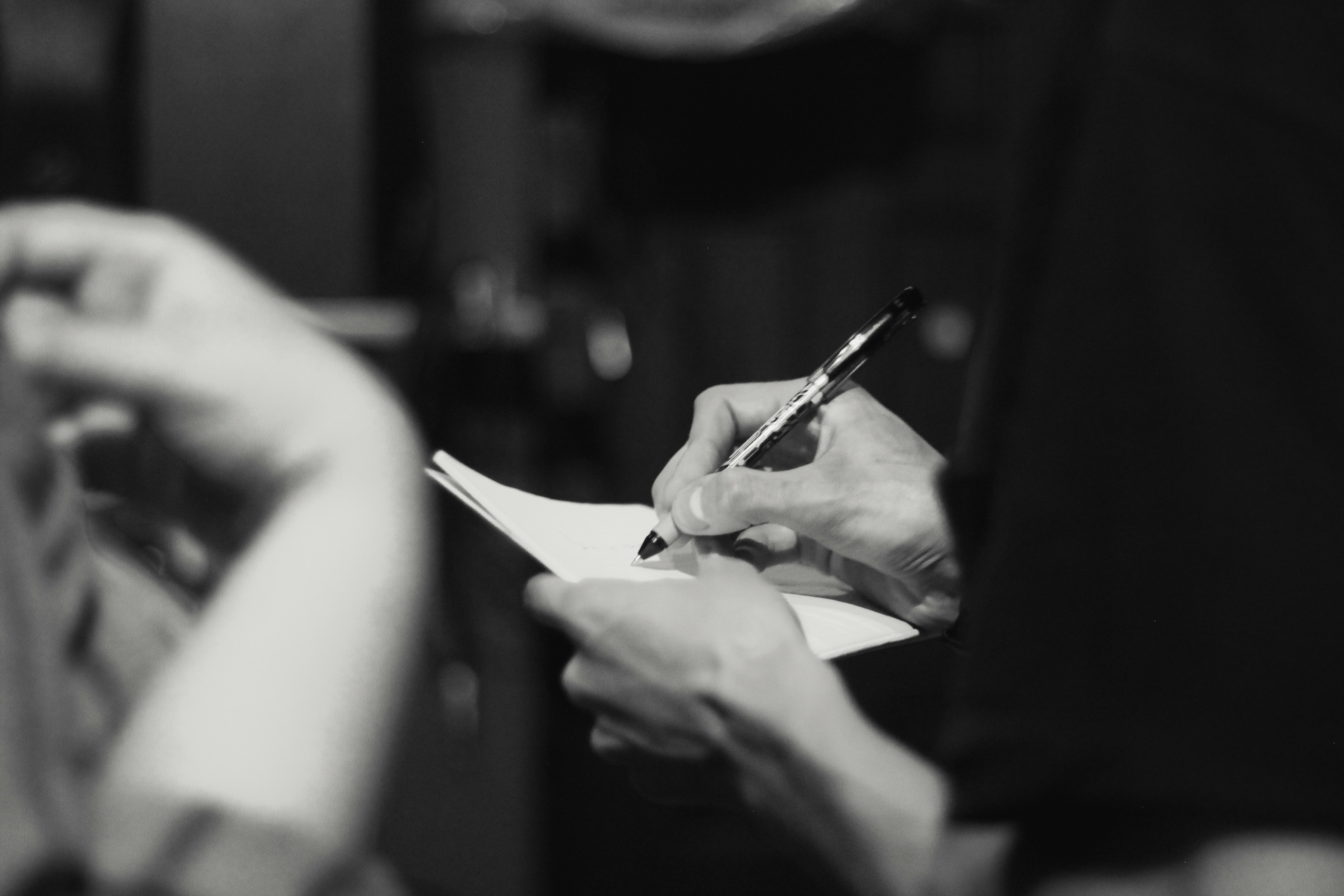 A hand taking notes during a planning session