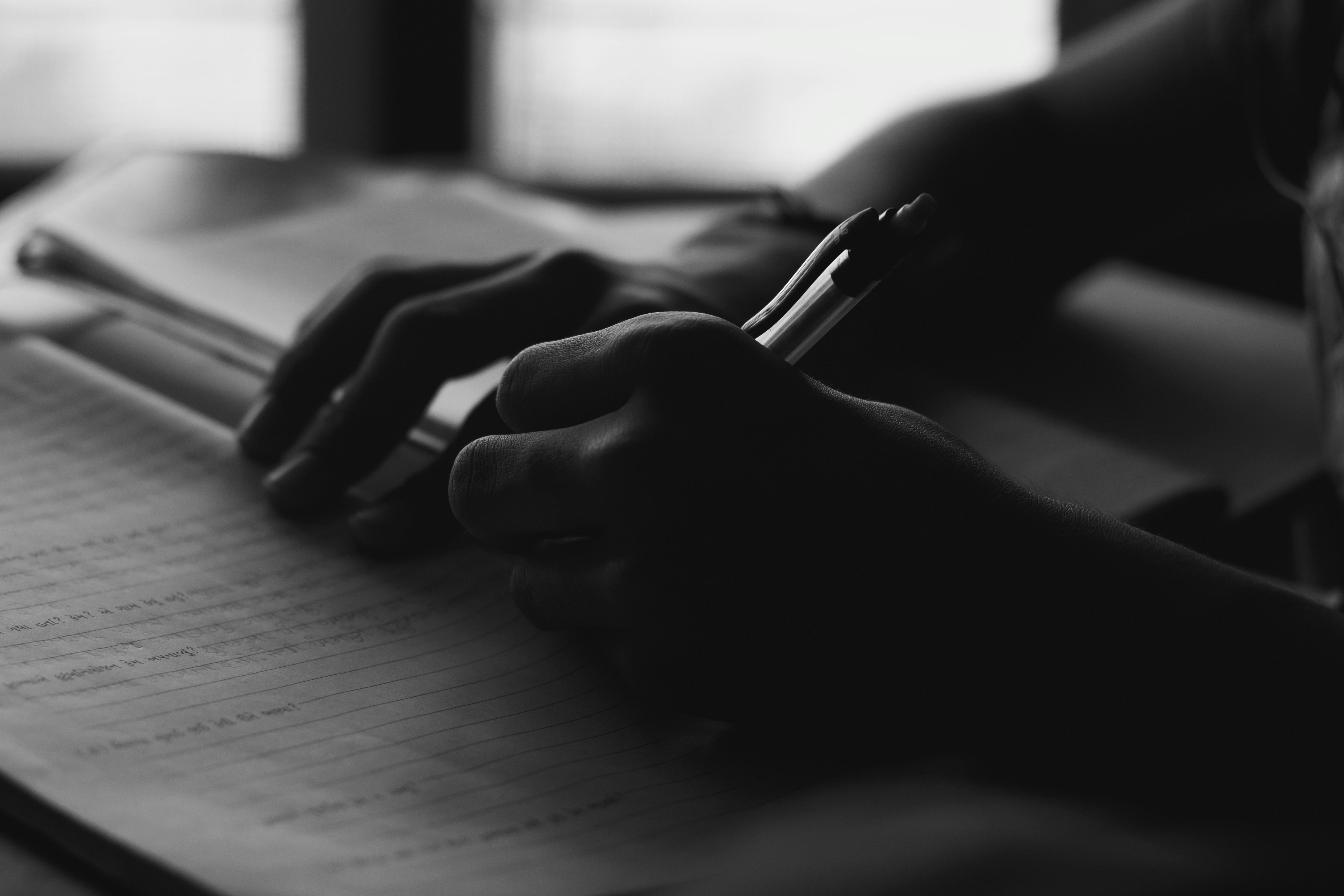 A person writing notes during a reflective coaching exercise